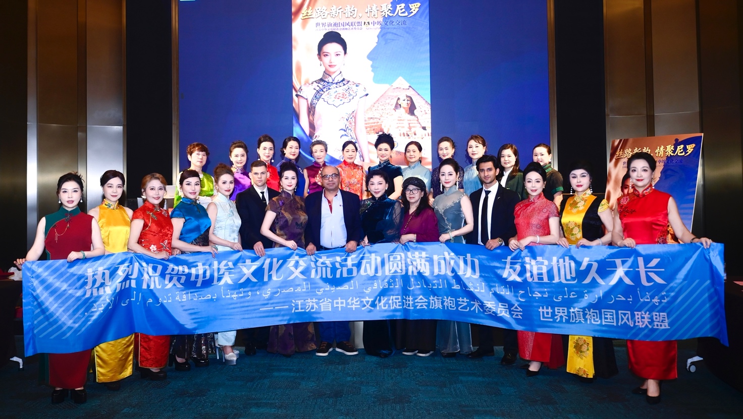 A group of people holding a blue banner

Description automatically generated